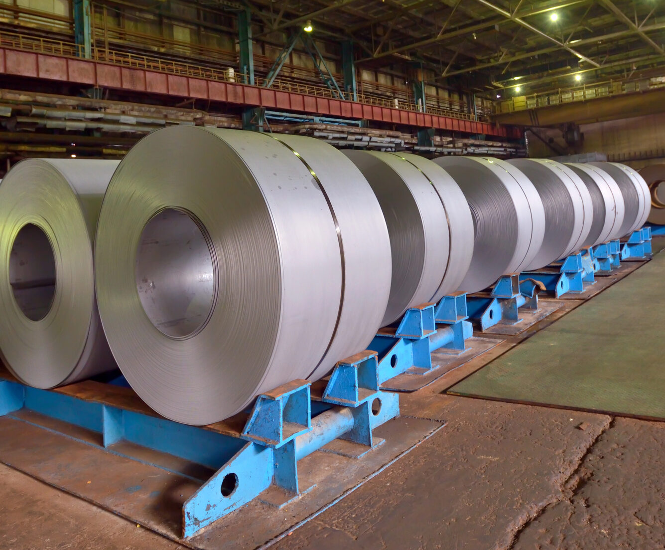 HRPO steel sheet and coil stock in an indoor metal processing facility.